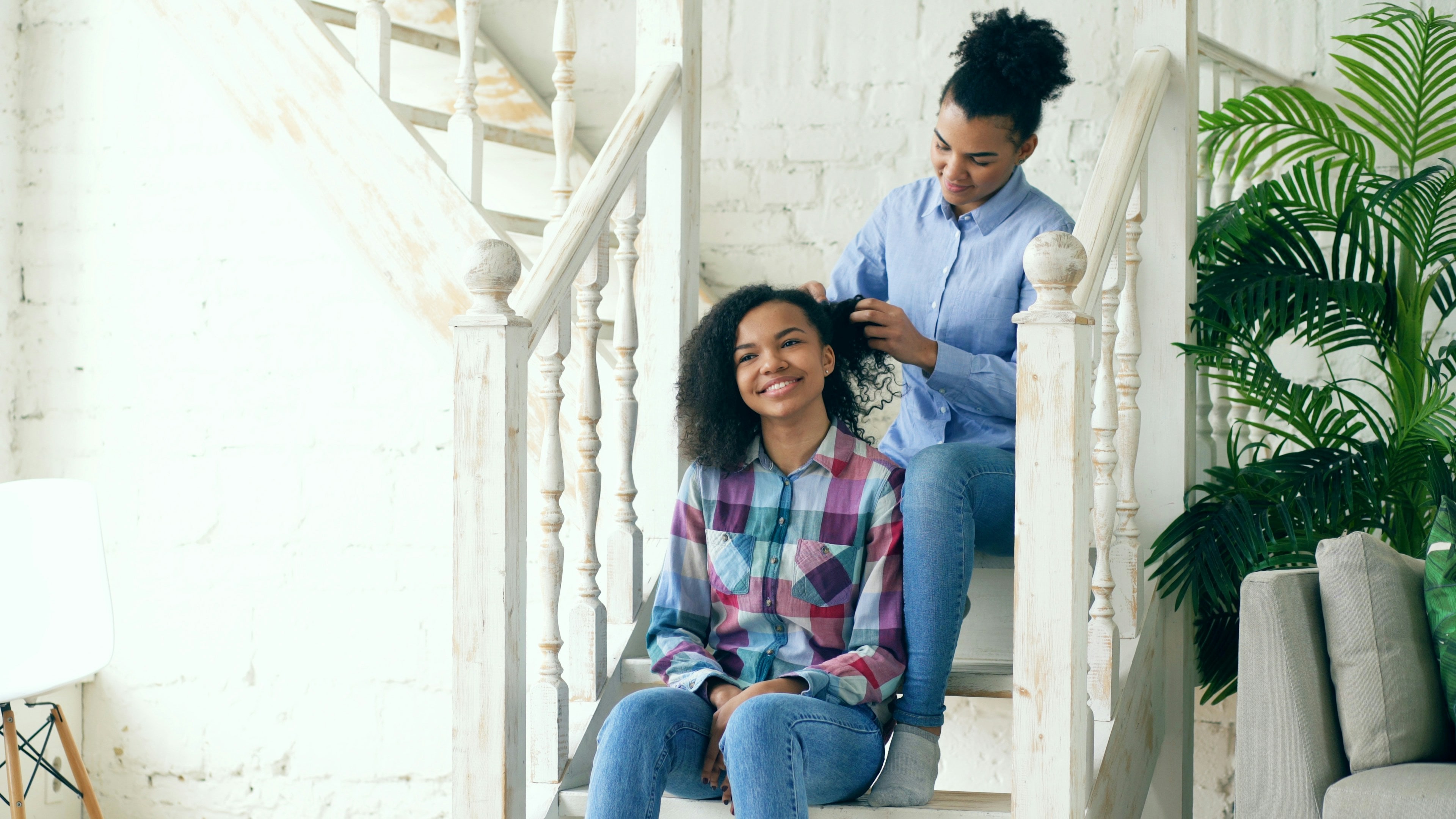A support worker sitting attentively with a resident in their home