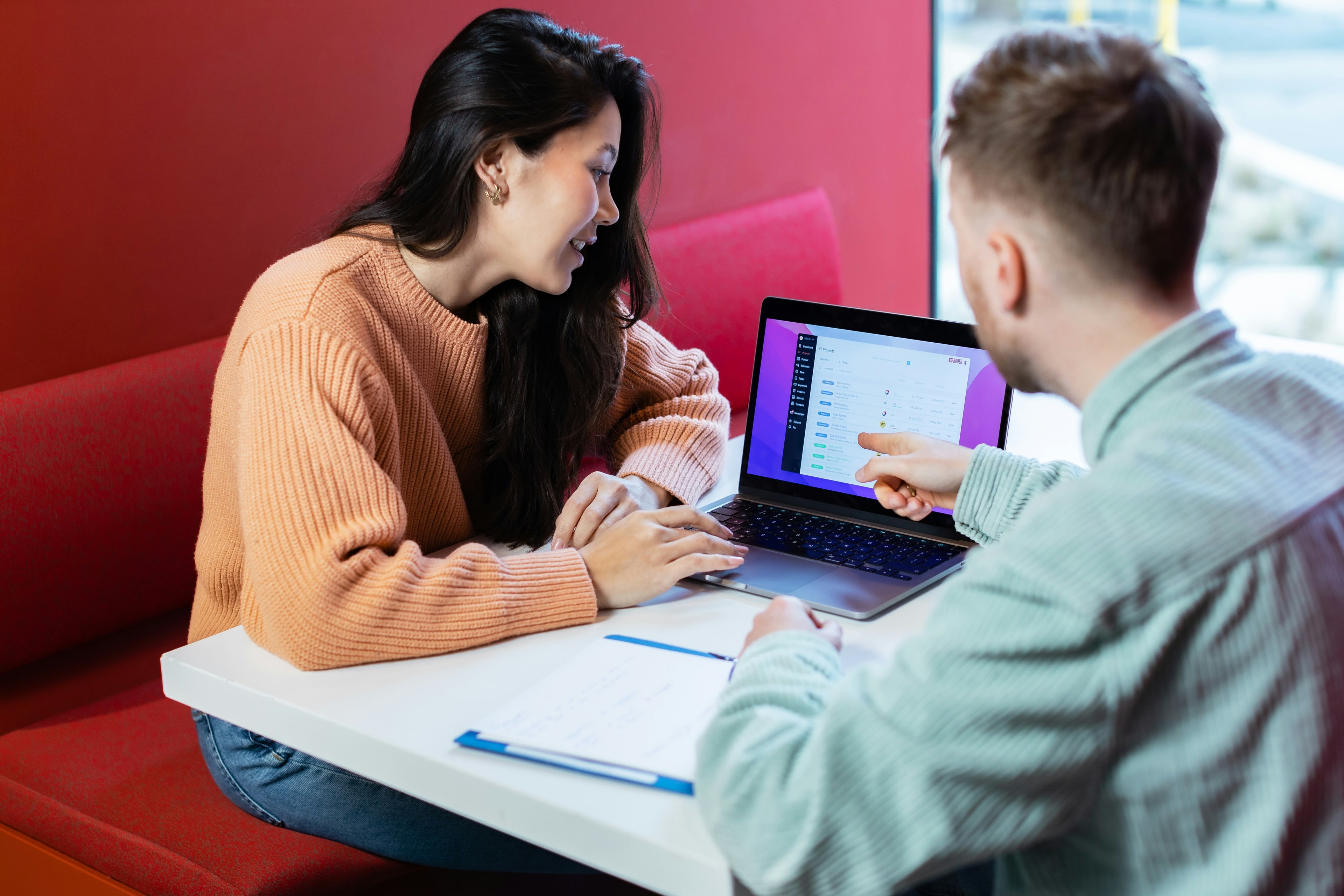A support worker reviewing a care plan with a resident on a tablet