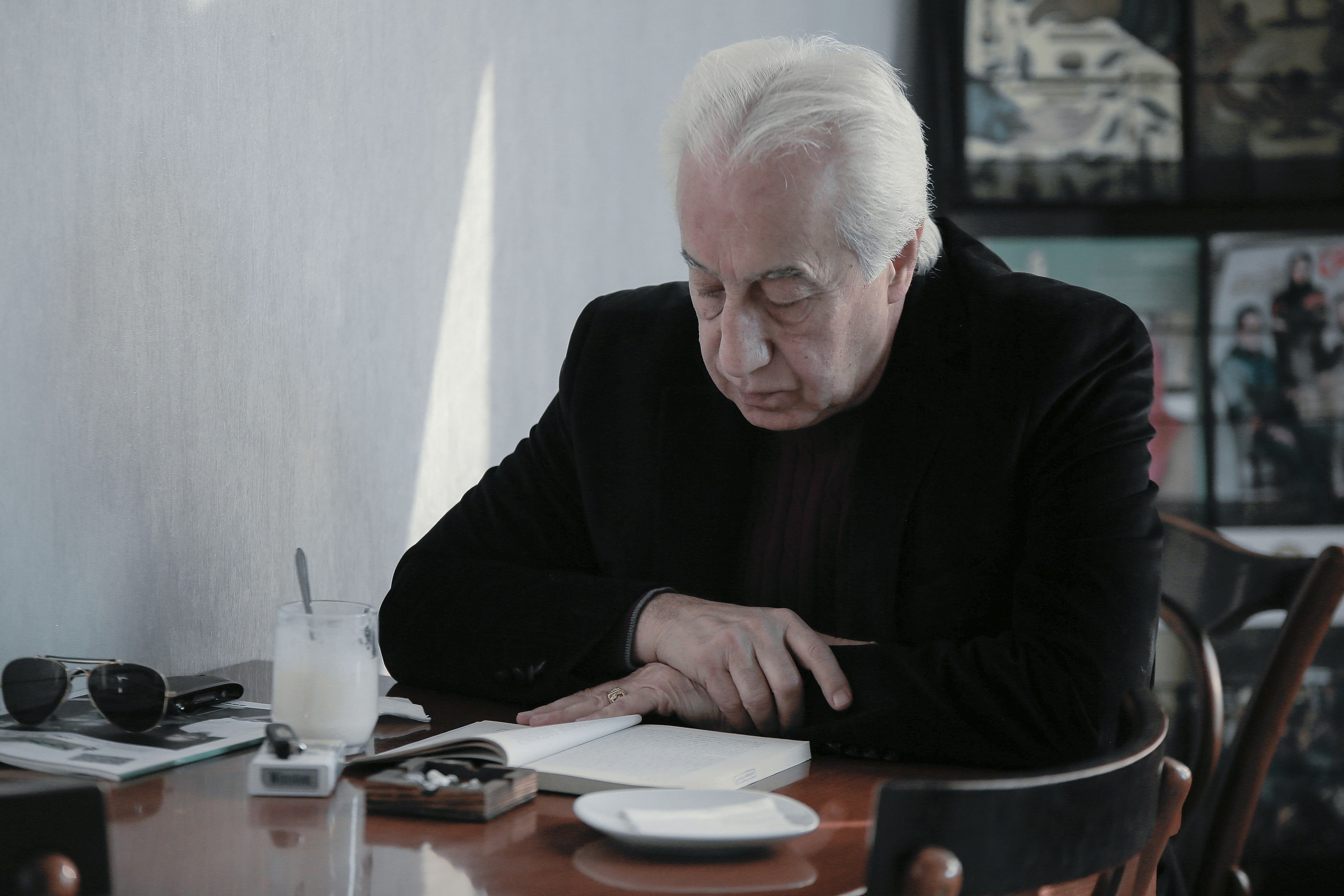 A person reading funding information at a table