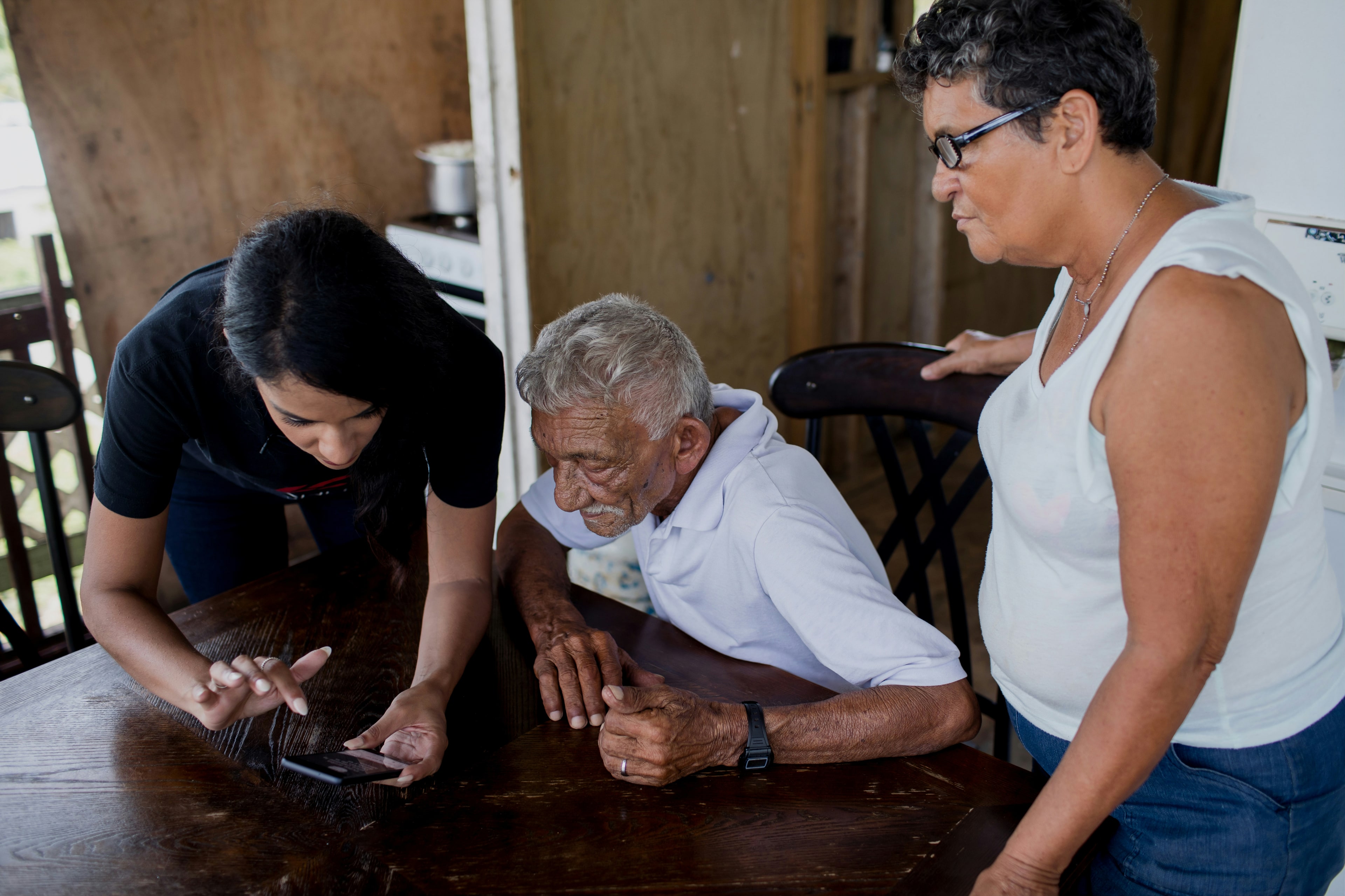 A familiar support worker greeting a resident warmly at their front door