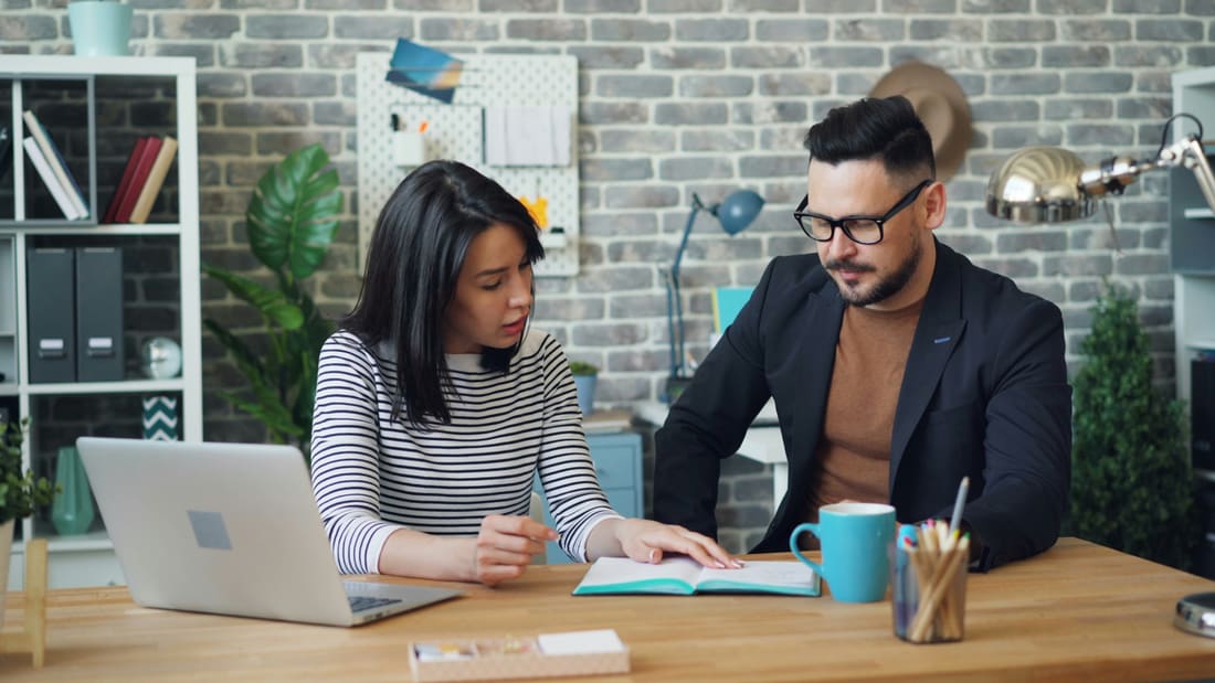 Two support workers reviewing notes together — a small, consistent team
