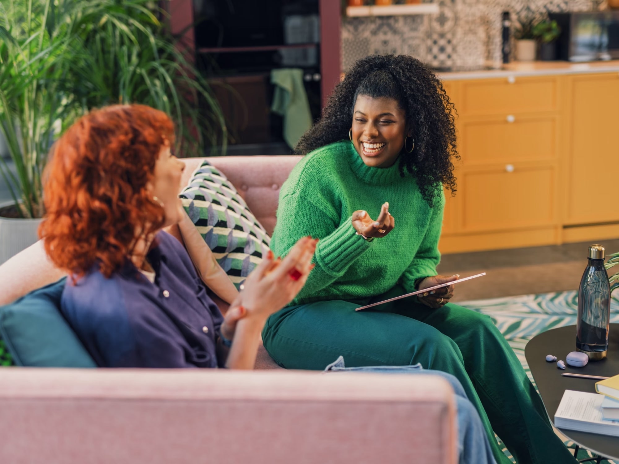 Two people in warm conversation on a sofa at home