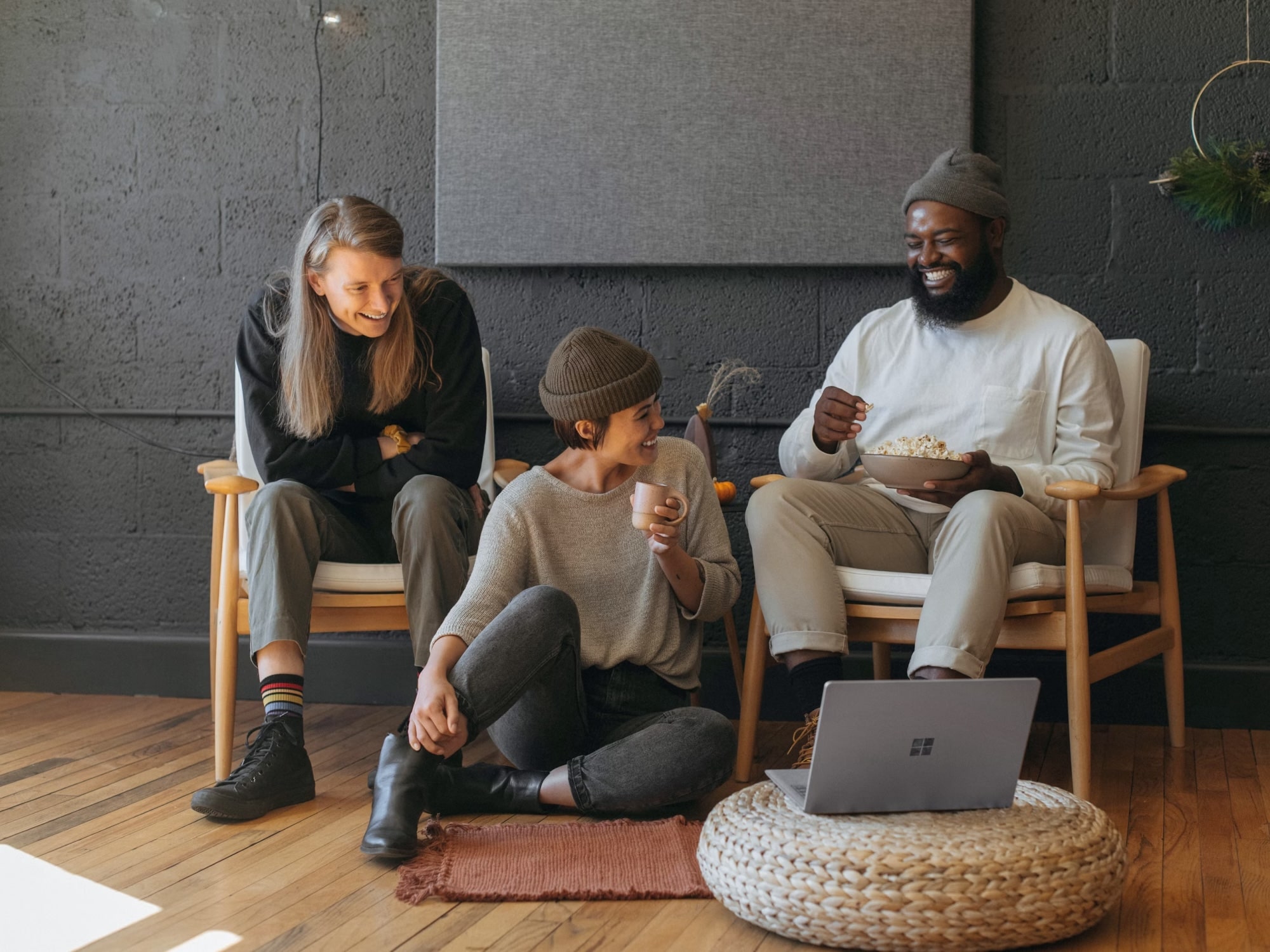 Three people relaxing and laughing together in a comfortable living room