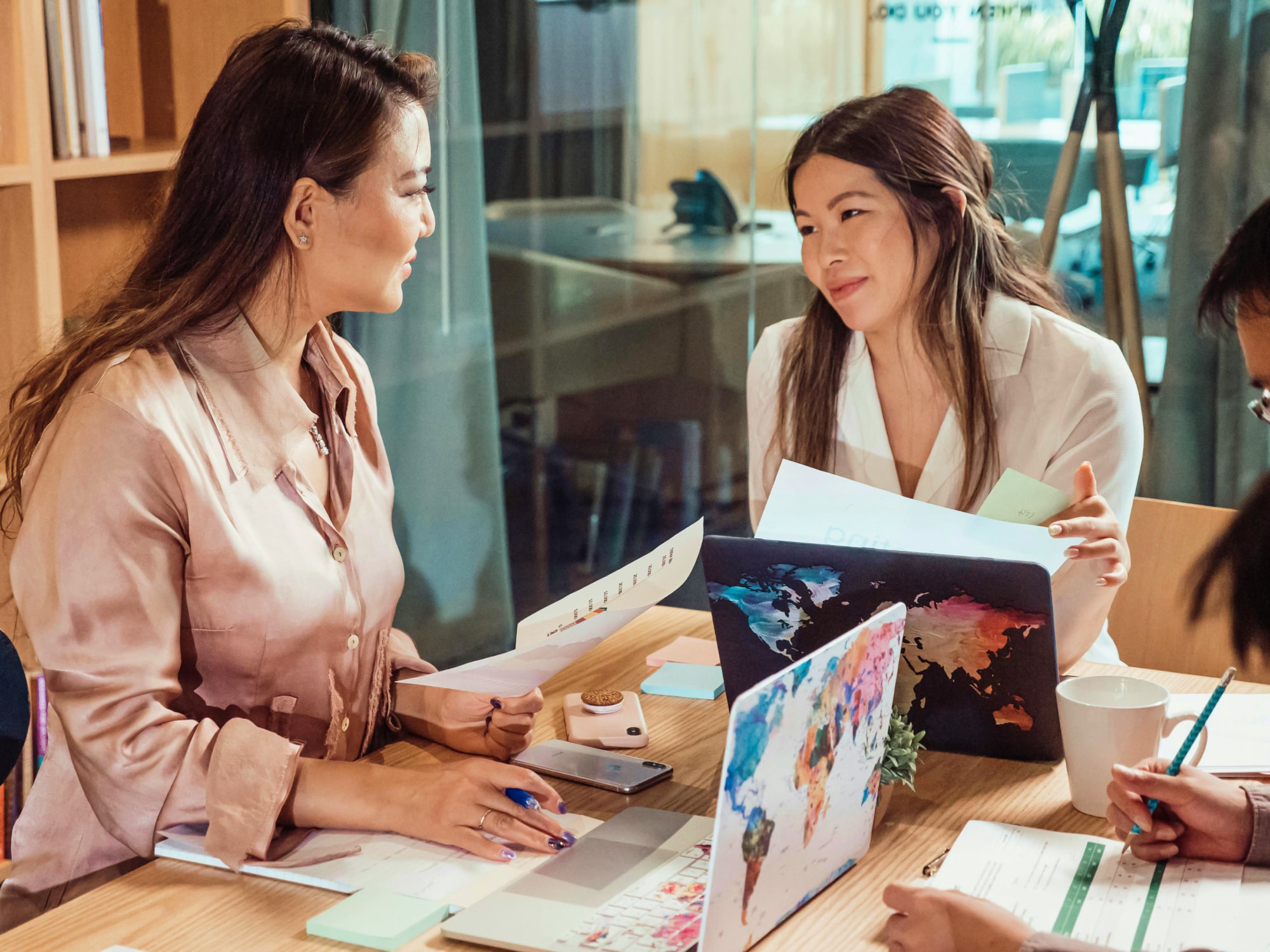 Two colleagues reviewing care notes together at a desk